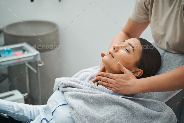 Young woman napping during an anti-wrinkle treatment
