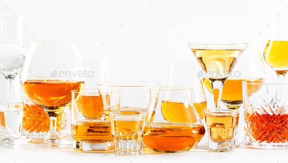 Strong alcohol drinks, hard liquors, spirits and distillates set in glasses: cognac, scotch