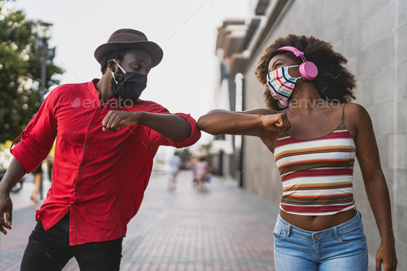 African friends wearing face protective mask while doing new social distance