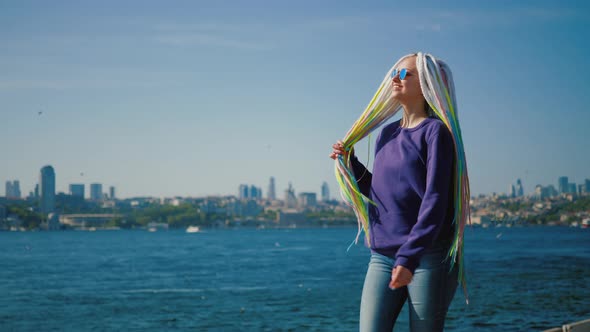 Young Hipster Woman Walking Along Embankment Against Istanbul and Bosphorus alt