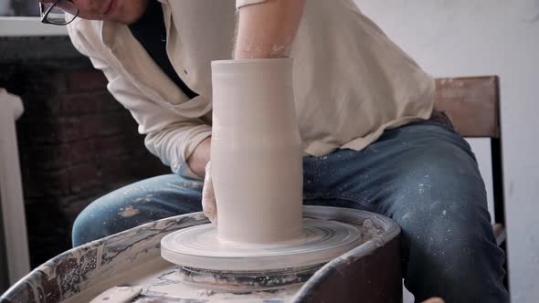 Craft Person Man Molding Pot in Small Workshop Studio