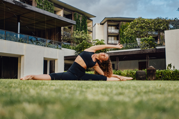Fitness woman doing yoga exercises inside courtyard