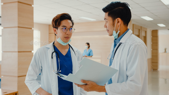 Asian doctors talk and discuss about patient's case in hospital. - Stock Photo - Images