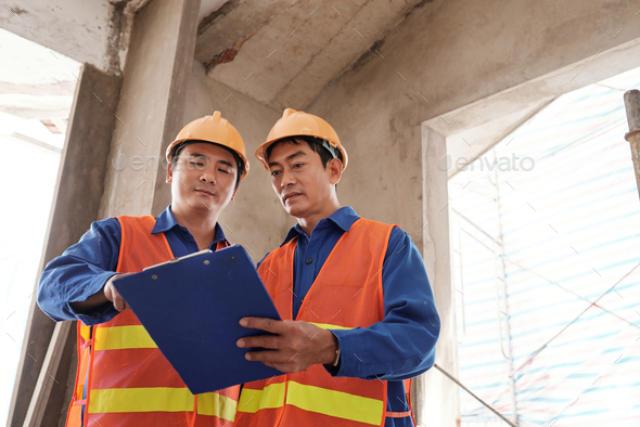 Contractor Checking Construction Progress Report