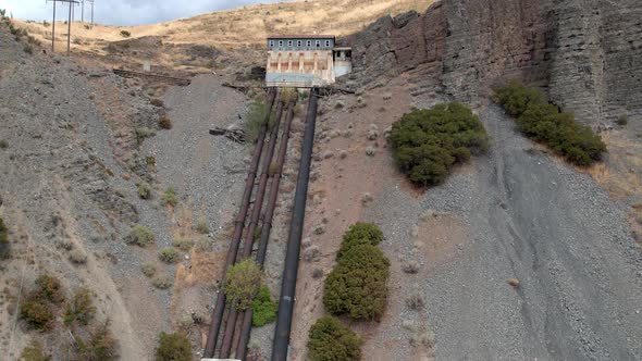 Aerial view of abandoned building on top of a hill alt