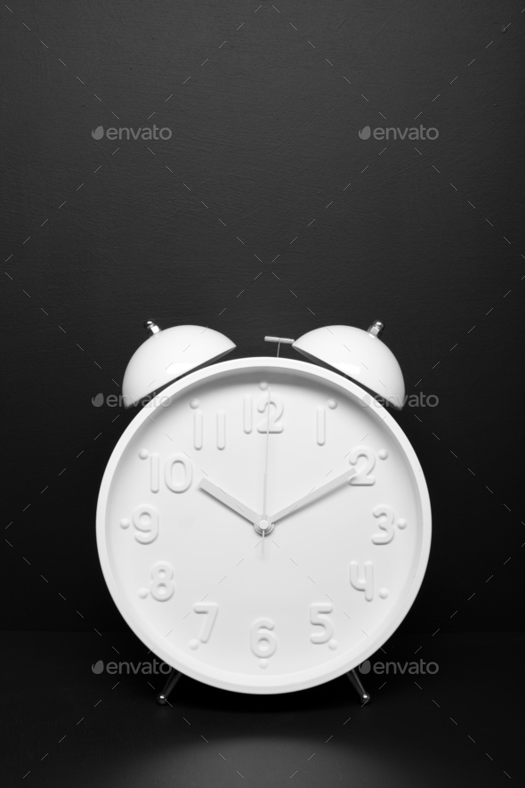 Retro alarm clock isolated on black background - Stock Photo - Images