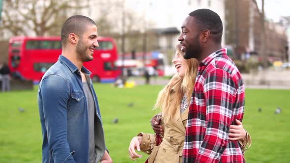Multiracial group of friends talking in London alt