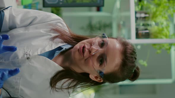 Vertical Video Pov of Chemist Woman in White Coat Analyzing with Biologists Team alt