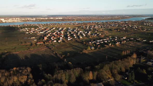 Aerial View of Small Modern Village Near River alt