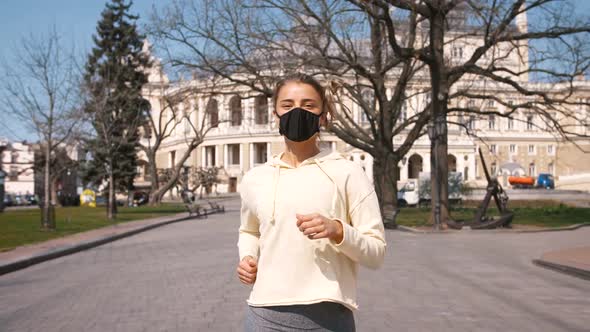 Portrait of Beautiful Young and Fit Woman Running and Jogging Alone in City Center Wearing alt