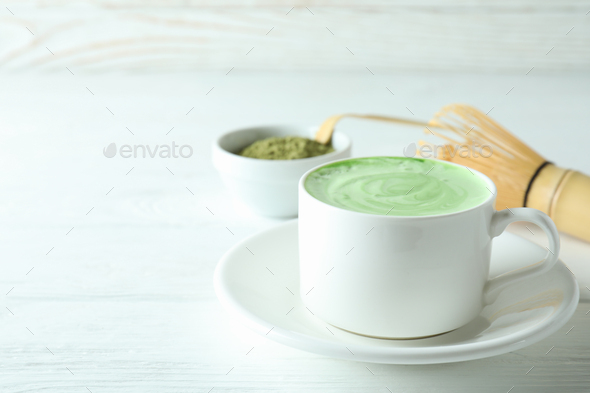 Matcha latte and accessories for making on white wooden table Stock Photo  by AtlasComposer