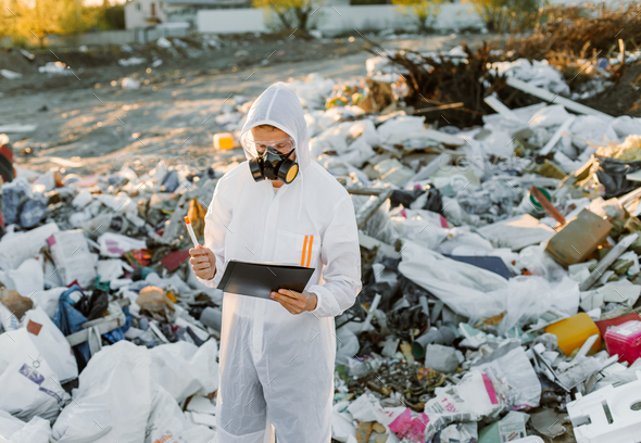 Researcher looking at plastic landfill analyzing environmental ...