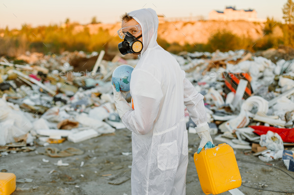 Researcher looking at plastic landfill analyzing environmental ...