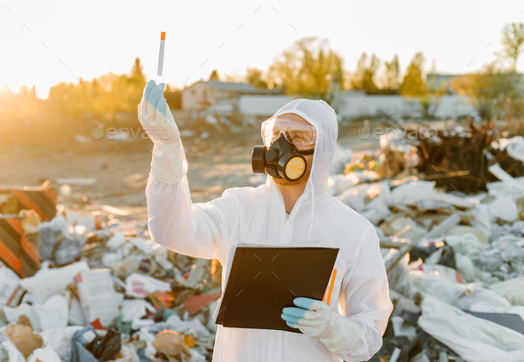 Researcher looking at plastic landfill analyzing environmental ...