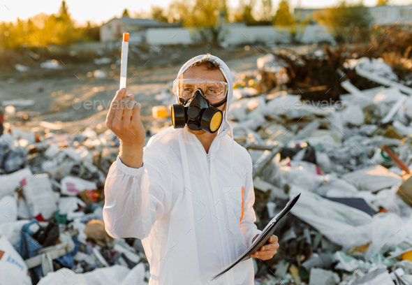 Researcher looking at plastic landfill analyzing environmental ...