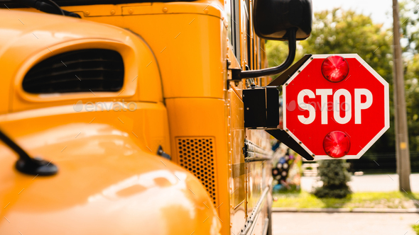 Yellow school bus. Stop sign. Be careful, schoolchildren crossing the road. New academic year