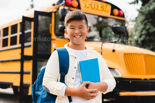 Asian korean japanese chinese schoolboy pupil student going back to school after summer holidays