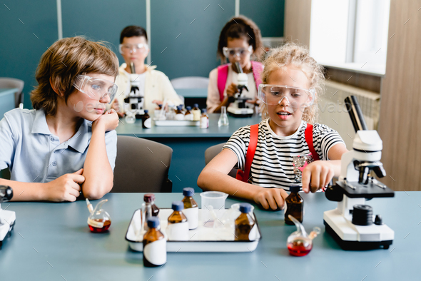 Classmates kids schoolchildren making experiments listening to the ...