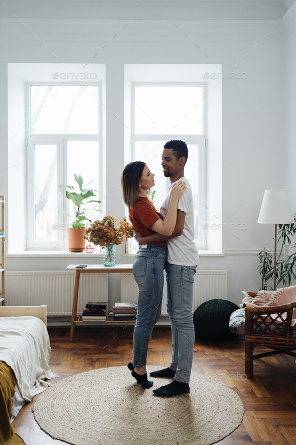 Mixed race couple dancing at home - Stock Photo - Images