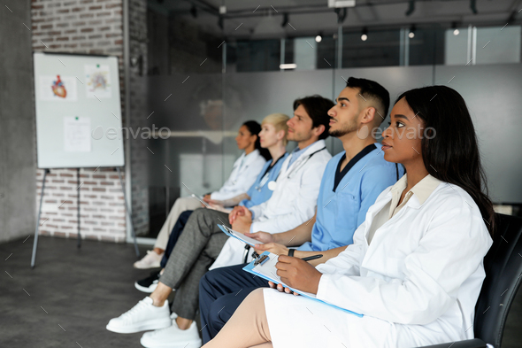 Professional multiethnic group of healthcare employees having medical conference