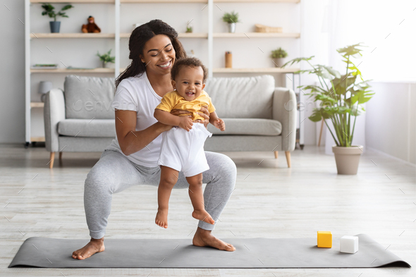 Weight Loss After Pregnancy. Black Mom Training At Home With Infant Baby