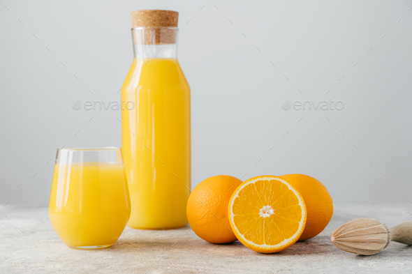 Glass jug with fresh orange juice on white background Stock Photo