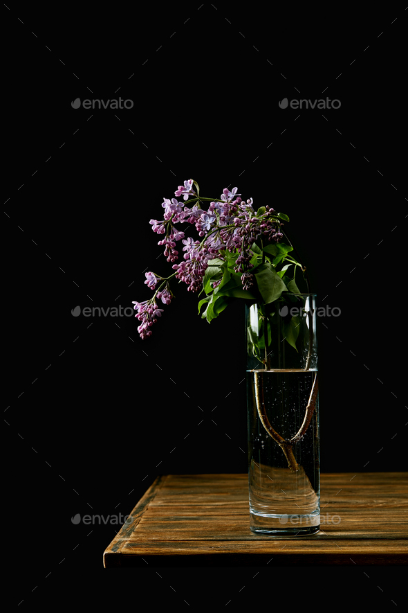 Still life lilac flowers in a vase on the table Stock Photo by