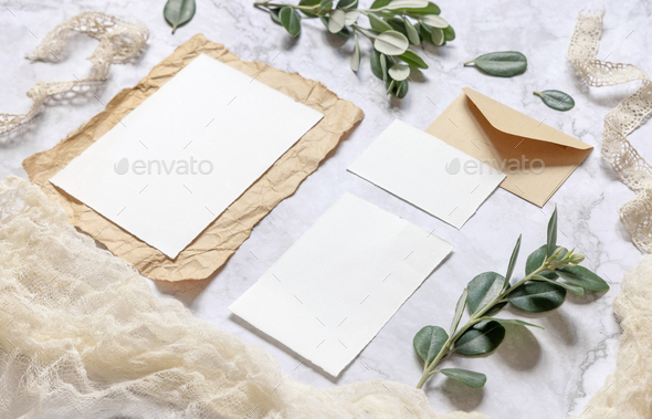 Wedding blank cards on a marble table with eucalyptus branches