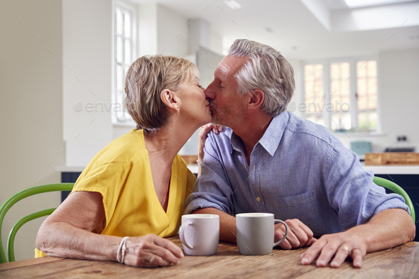 Retired Couple Sitting Outdoors At Home Having Morning Coffee Together  Stock Photo - Download Image Now - iStock