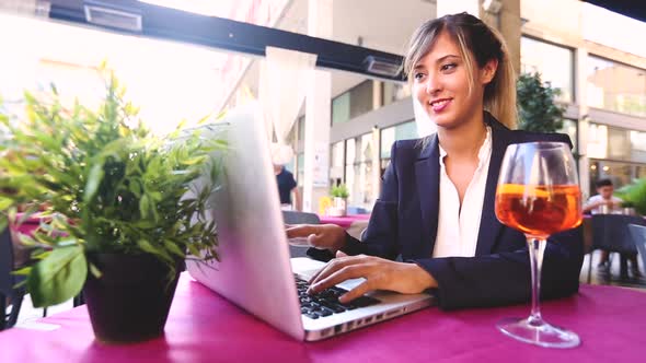 Young businesswoman with laptop during a break