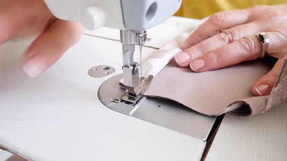 Senior Female Sewing Cloth on Machine