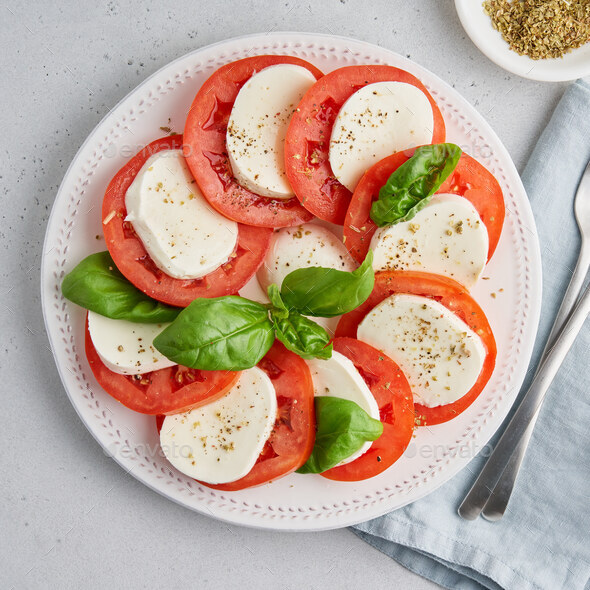 Closeup of italian caprese appetizer. Healthy rustic vegetarian salad. Classic mediterranean meal - Stock Photo - Images
