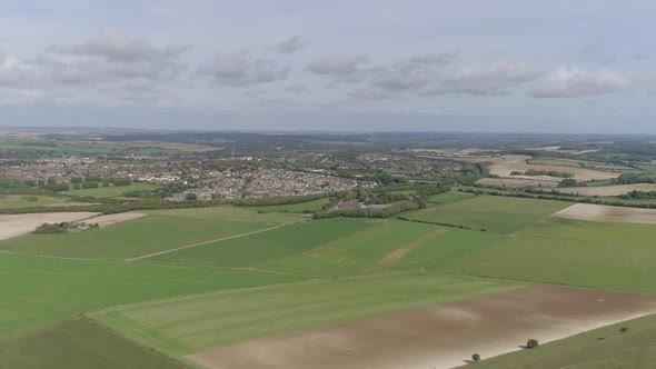 Aerial tracking forward towards the historic town of Dorchester from the south. Old Roman town, with alt
