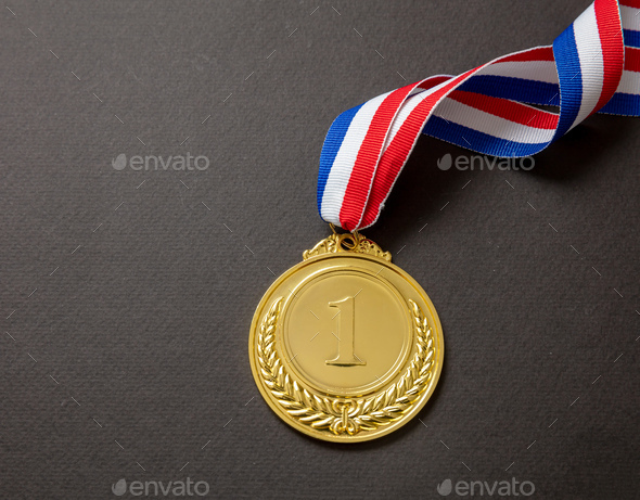 Gold medal. Champion trophy award and ribbon. Prize in sport for winner isolated on black background