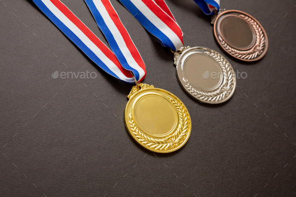 Gold, silver and bronze medals set on black background. Sports athletes winners prize