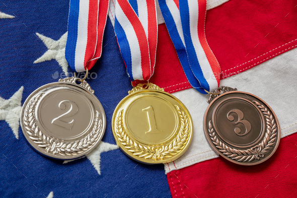 Gold, silver and bronze medals set on USA flag background. Sports athletes winners prize