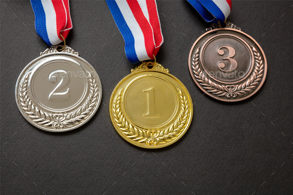 Gold, silver and bronze medals set on black background. Sports athletes winners prize