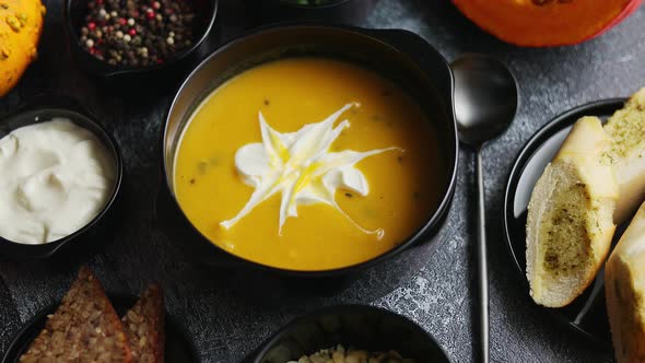 Homemade Pumpkin Soup with Cream and Sides