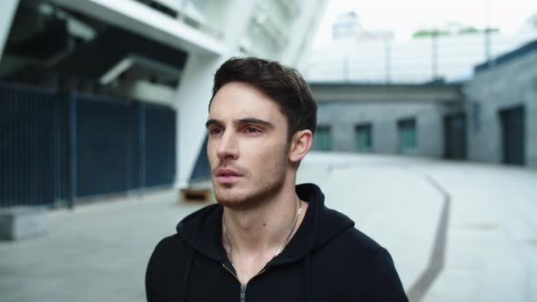 Portrait of Sexy Man Walking Street. Close Up Brutal Man Going on Urban Street. alt