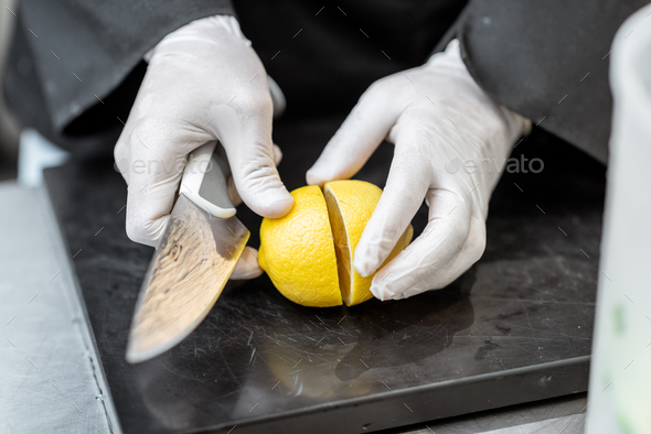 Chef cutting lemon