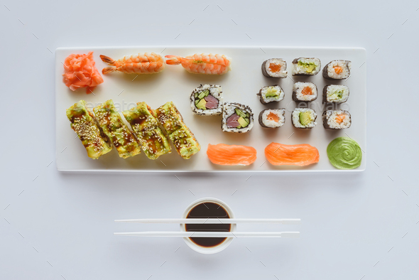 Sushi roll set with wasabi, ginger and soy sauce . Stock Photo by