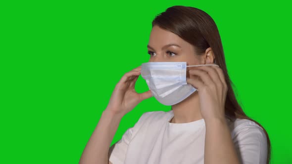 Young Caucasian Beautiful Woman Put on Protective Face Mask