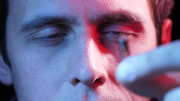 Man Looks at the Chip for Implantation alt