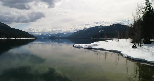 Snowmobile Enjoying Nature Snow Lake Water Edge Winter Sports Scene Aerial Drone alt