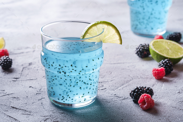 Tasty blue colored cocktail drink with basil chia seeds citrus