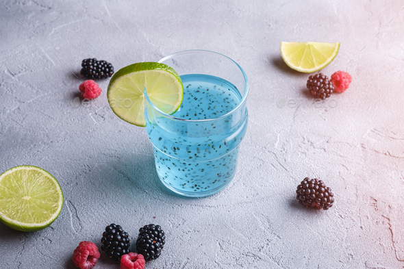 Tasty blue colored cocktail drink with basil chia seeds citrus