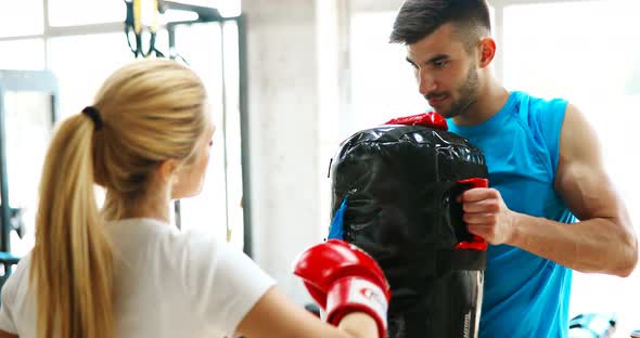 Picture of Woman Wearing Boxing Gloves and Her Trainer