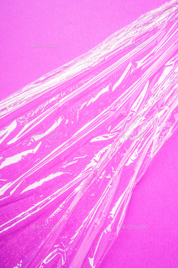 Stretch wrap plastic on pink background, minimalistic creative layout