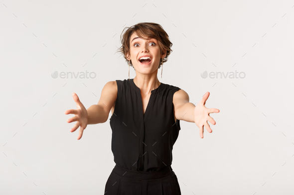 Image of tempted and amazed young elegant woman reaching hands forward. Girl  stretching arms to hold Stock Photo by benzoix