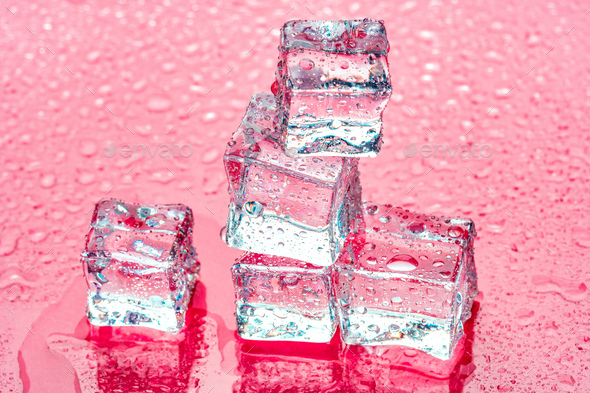 Square melting ice cubes on wet table Stock Photo by FabrikaPhoto